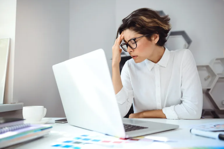 Young beautiful businesswoman working with laptop at workplace in office